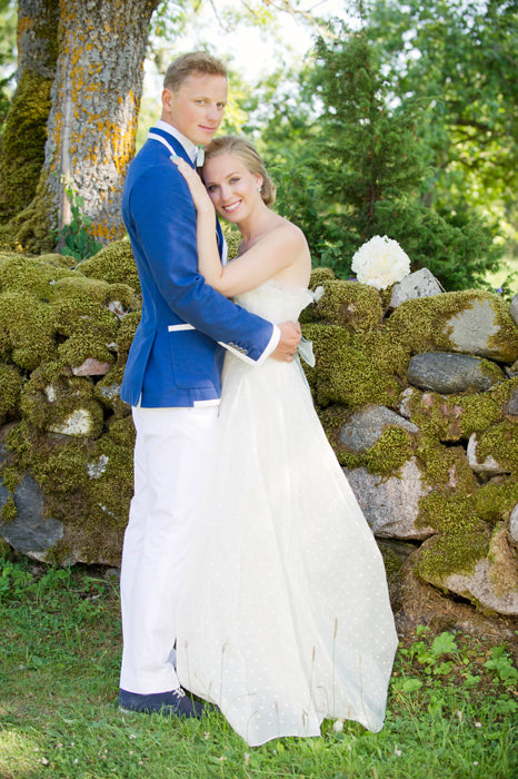 Amanjeda bride and groom standing together outdoors
