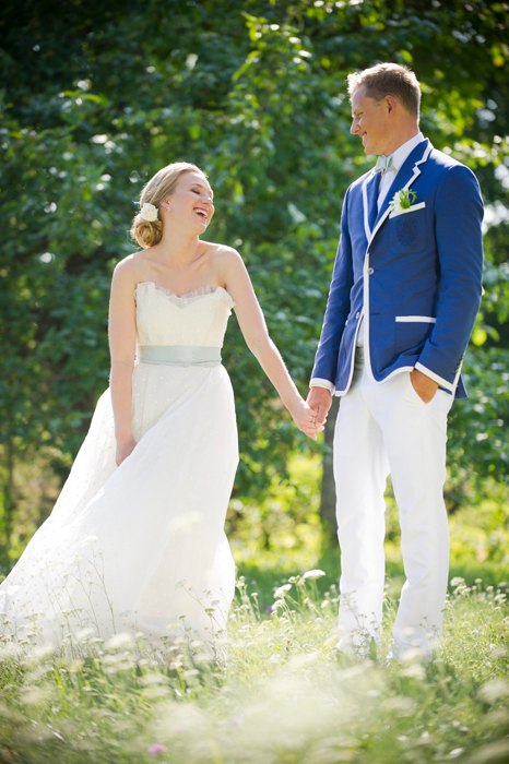 Bride in a strapless gown with a softly flared skirt beside the groom