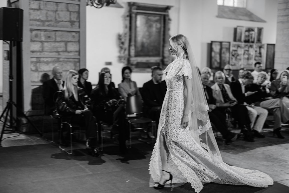 Amanjeda lace gown with short sleeves and a train shown in motion