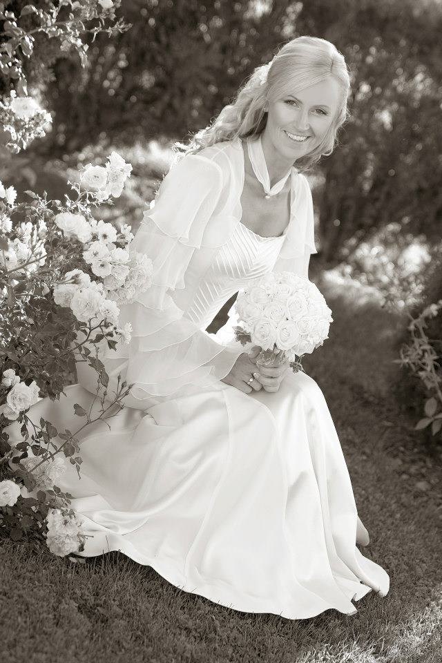 Bride in a gown with a pleated bodice and soft cape sleeves