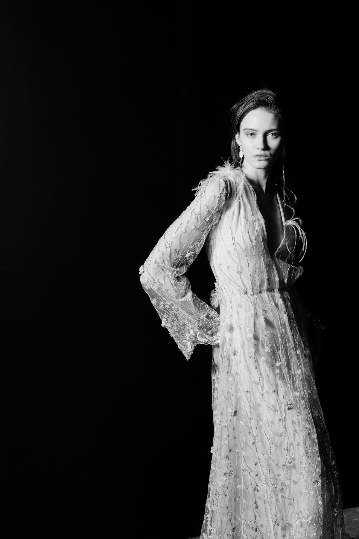 Sheer embroidered bridal gown with handmade feather details