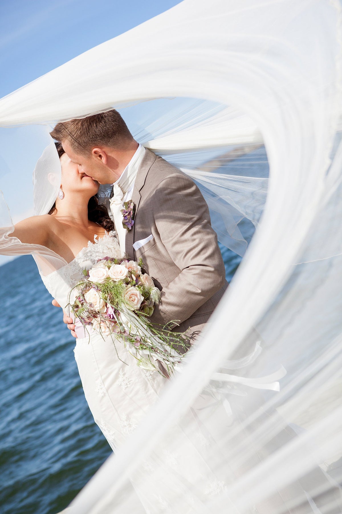 Amanjeda bride and groom beneath a veil