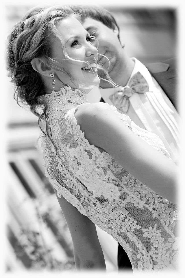Bride in a gown with a sheer lace back, long sleeves and button fastening