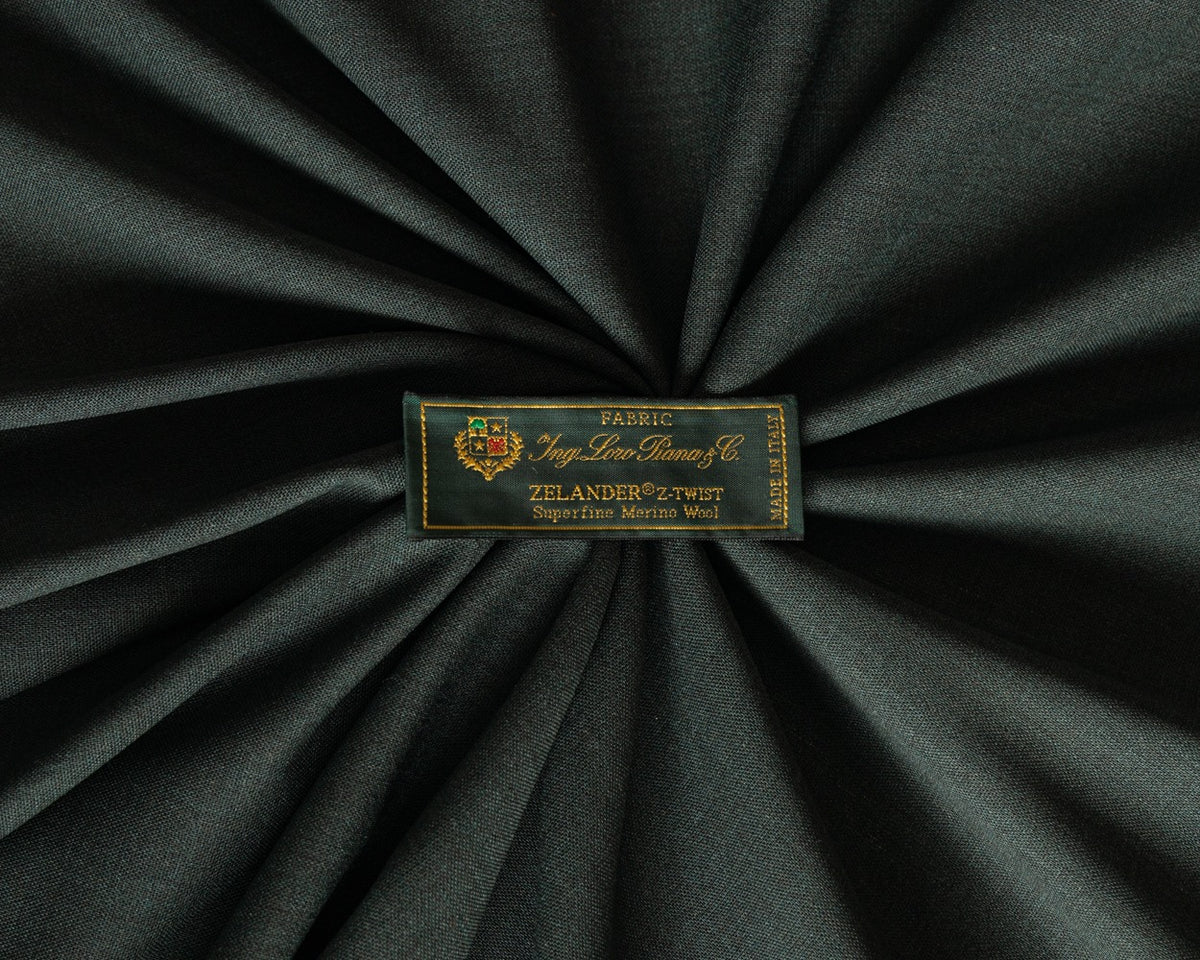 Loro Piana green merino wool fabric with woven brand label